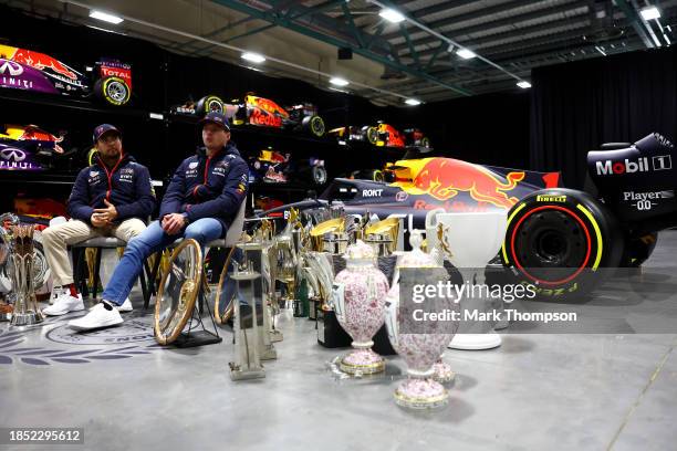 Sergio Perez of Mexico and Oracle Red Bull Racing and Max Verstappen of the Netherlands and Oracle Red Bull Racing look on surrounded with trophies...