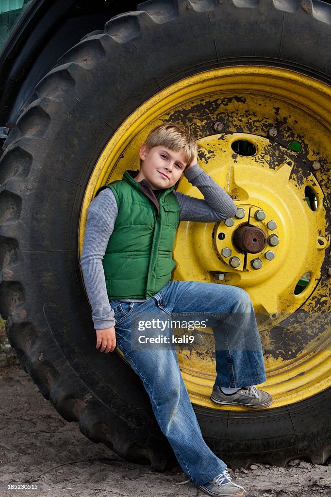 Boy on tractor wheel