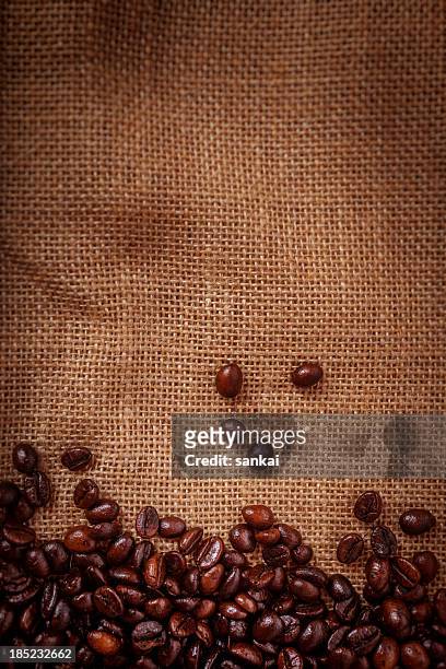coffee beans on burlpab background - hessian stock pictures, royalty-free photos & images