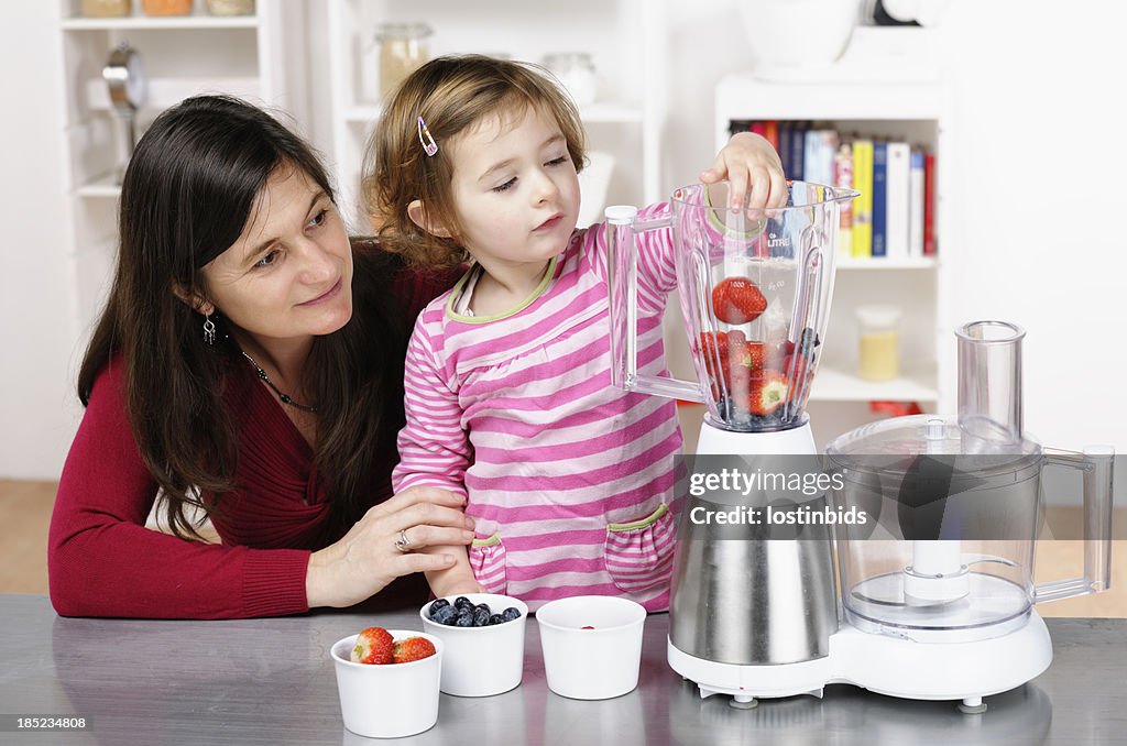 Caucasian Toddler Helping Her Mother Preparing A Smoothie