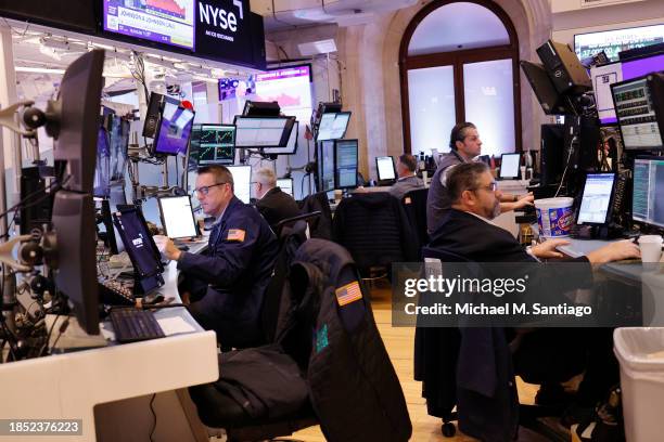 Traders work on the floor of the New York Stock Exchange during morning trading on December 13, 2023 in New York City. Stocks opened up mixed amid...