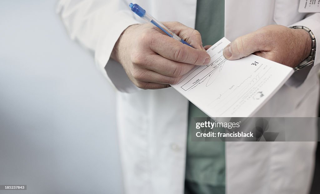 Doctor filling out a prescription