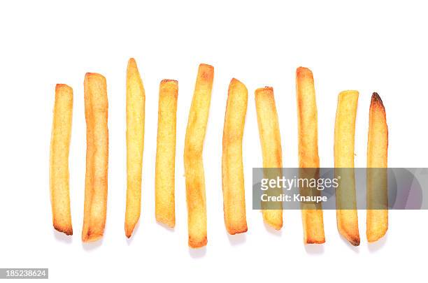 french fries in a row on white background - gebakken in de pan stockfoto's en -beelden