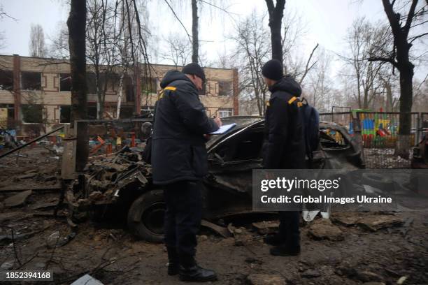 Criminologists record the destruction of a car following a missile explosion in Dniprovskyi district on December 13, 2023 in Kyiv, Ukraine. For the...