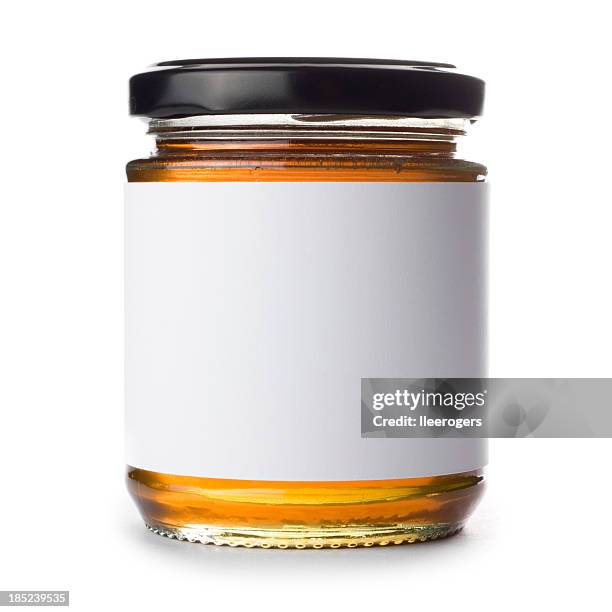 jar of honey with blank label on a white background - honing stockfoto's en -beelden