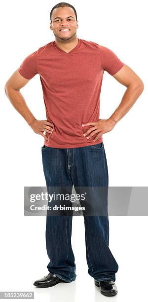 smiling young man standing with hands on hips - man hand on hip stock pictures, royalty-free photos & images