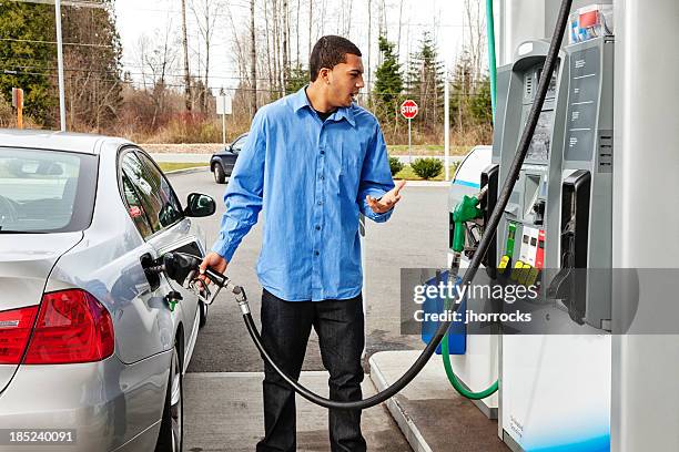 gas station frustration - fuel price stockfoto's en -beelden