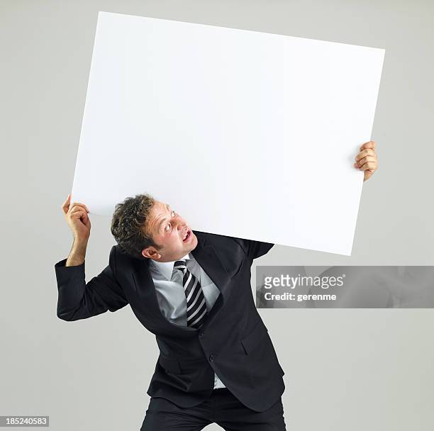 geschäftsmann holding blank sign - carrying sign stock-fotos und bilder