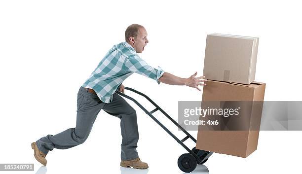 man carrying cardboard boxes in a warehouse - unbalance stockfoto's en -beelden