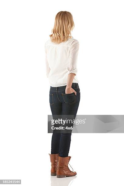 woman standing with her hands in pockets - full body isolated stockfoto's en -beelden