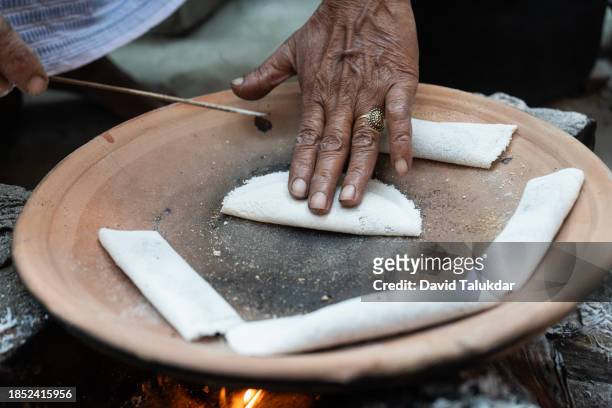 making assamese traditional rice cake or pitha - bihu stock pictures, royalty-free photos & images