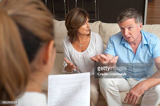 couple arguing in counselling session with a doctor - couple counselling stock pictures, royalty-free photos & images