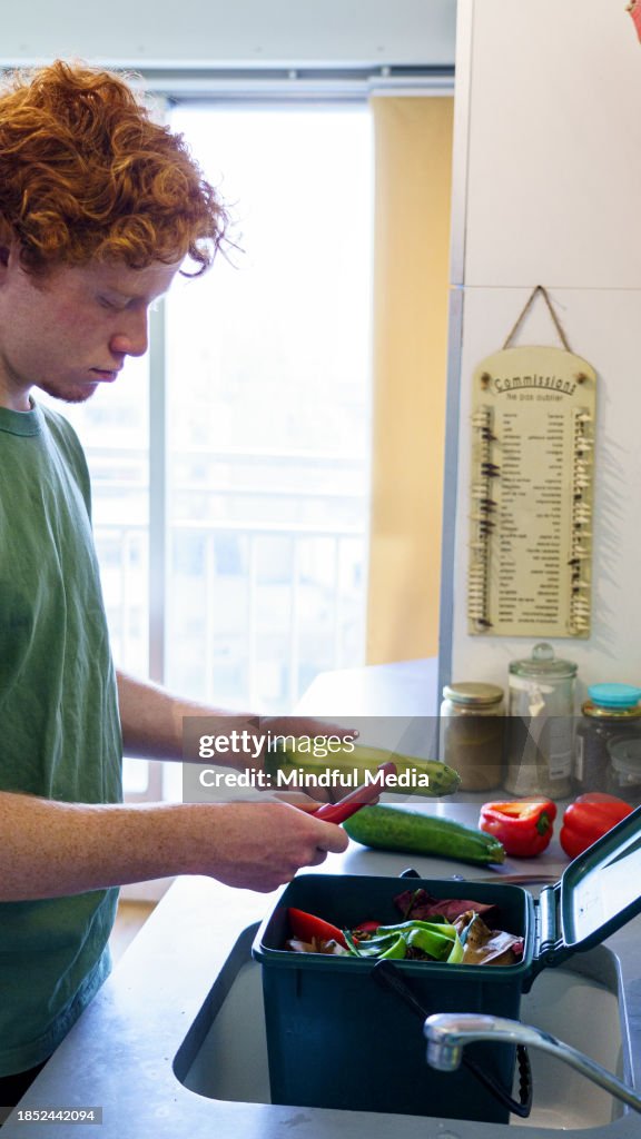 Young man making compost at home