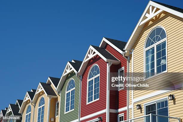 brightly coloured town houses - terraced houses stock pictures, royalty-free photos & images