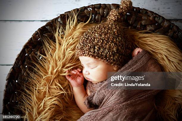 swaddled newborn sleeping on fur - elf hat stock pictures, royalty-free photos & images