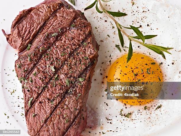 steak and sunny side up egg with seasoning - steakhouse stock pictures, royalty-free photos & images