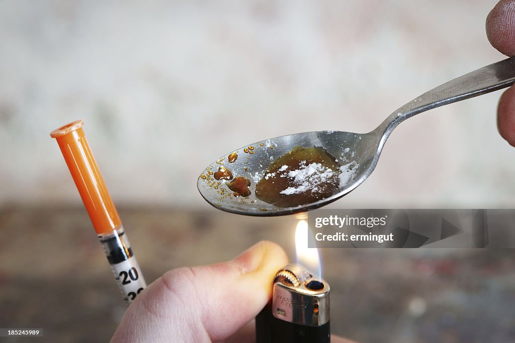 Addict preparing drugs