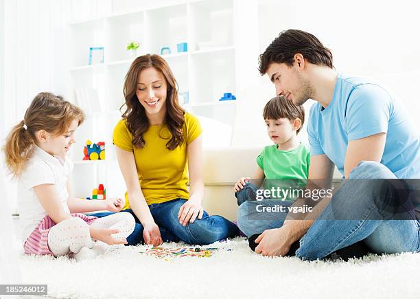 family playing board game at home. - 4 people playing games stock pictures, royalty-free photos & images