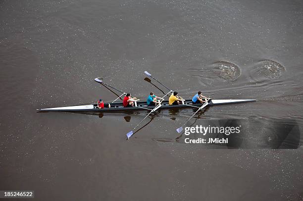 overhead view of men rowing a four person scull. - crew rowing stock pictures, royalty-free photos & images