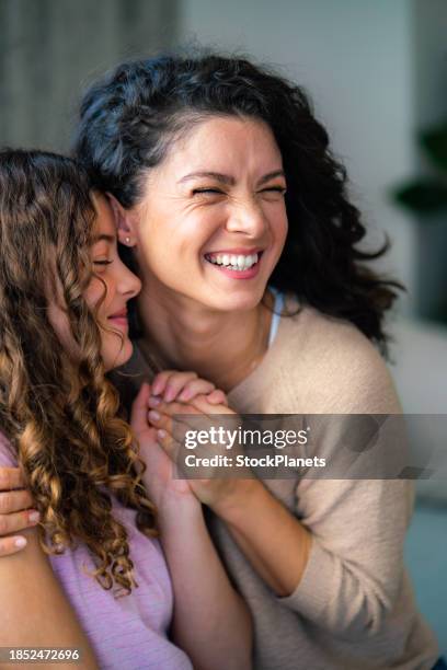 candid embrace of mother and daughter at home - family time stock pictures, royalty-free photos & images