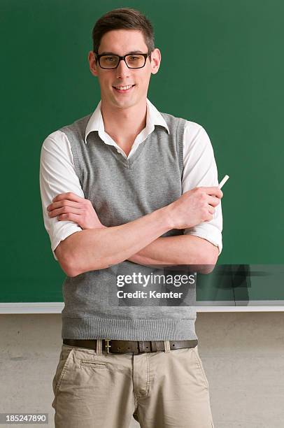 student with crossed arms at blackboard - nerd sweater stock pictures, royalty-free photos & images