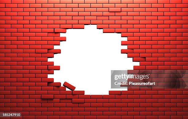 hole in a brik wall - brickwall stockfoto's en -beelden