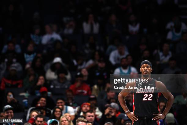 Jimmy Butler of the Miami Heat looks on during the second half of their game against the Charlotte Hornets at Spectrum Center on December 11, 2023 in...