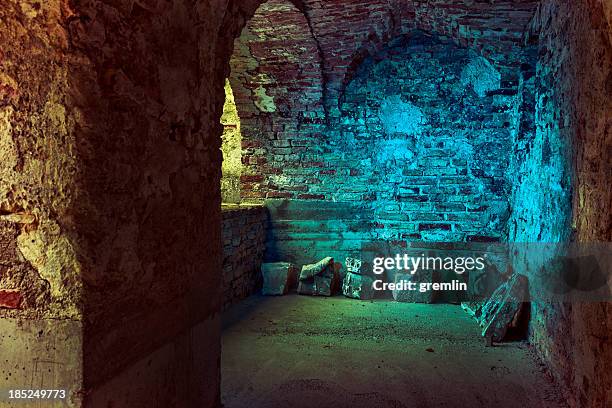 old stone arcades in a derelict, abandoned castle - dungeon stock pictures, royalty-free photos & images