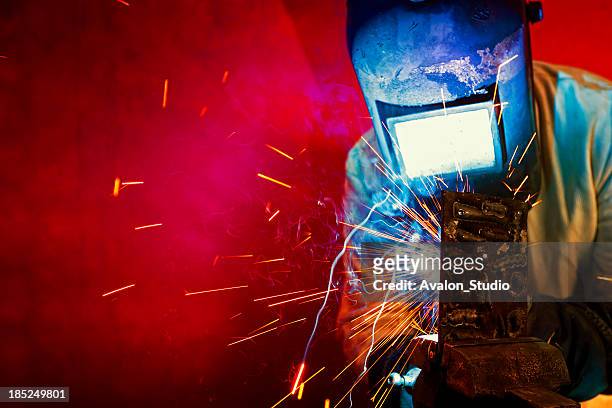 welder welding, sparks fly. - welder stock pictures, royalty-free photos & images