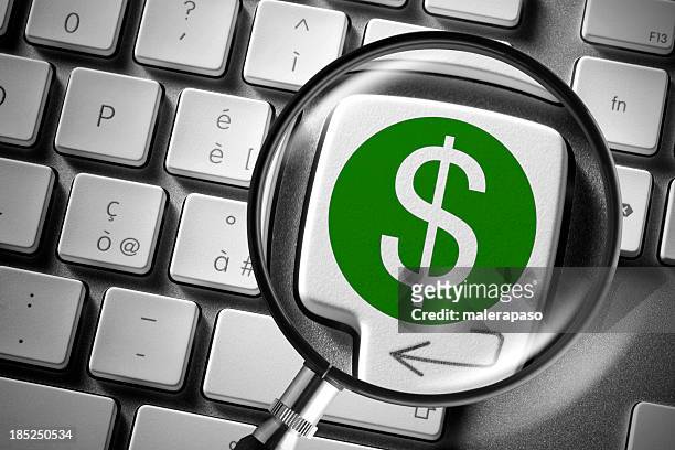 computer keyboard with dollar key enlarged by a magnifying glass. - dollar sign key stock pictures, royalty-free photos & images