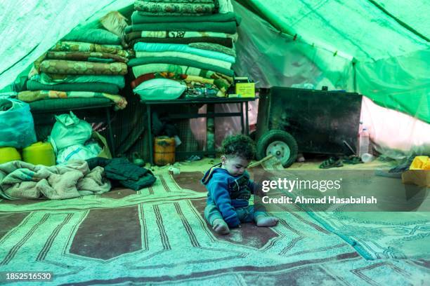 Displaced Palestinian child pictured in makeshift tent on December 13, 2023 in Al-Mawasi, Rafah, Gaza. A so-called safe zone where Palestinians have...
