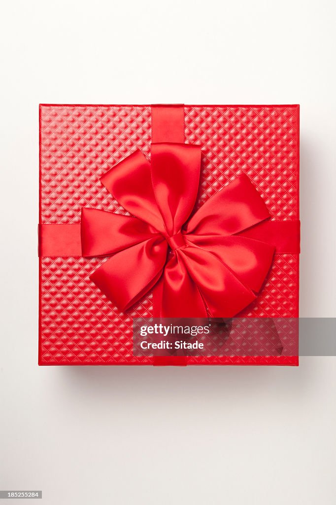 Red gift box tied with red ribbon and large bow