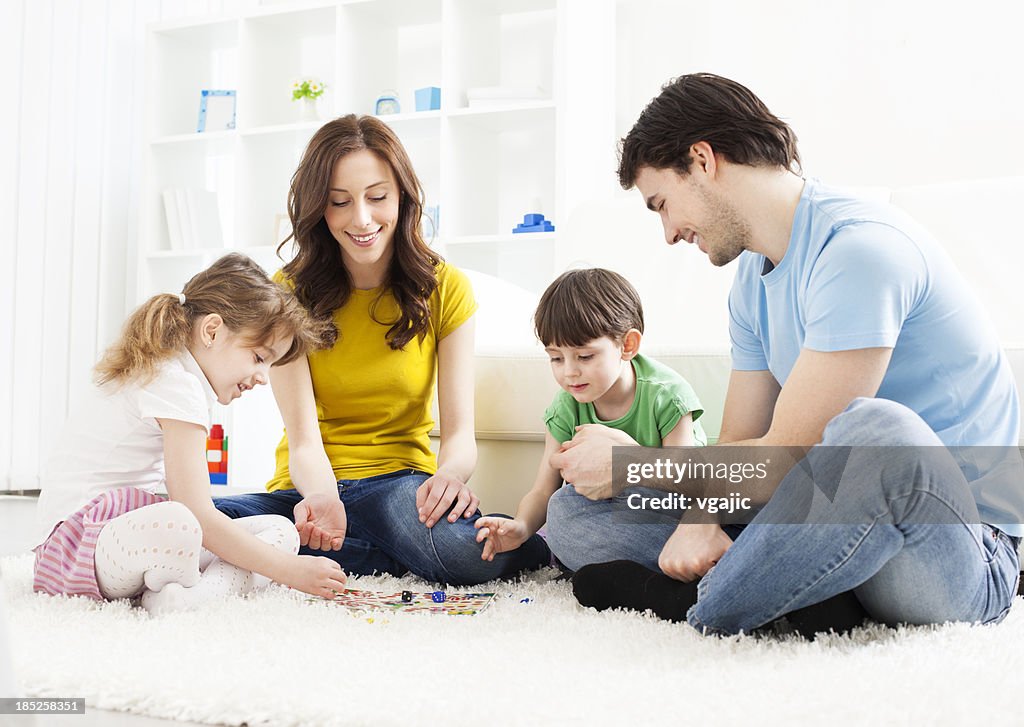 Family Playing Board Game at home.