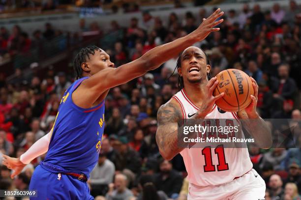 DeMar DeRozan of the Chicago Bulls goes up for a layup against Peyton Watson of the Denver Nuggets during the second half at the United Center on...