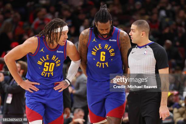 Aaron Gordon and DeAndre Jordan of the Denver Nuggets argue with referee Mousa Dagher after Nikola Jokic was ejected from the game against the...