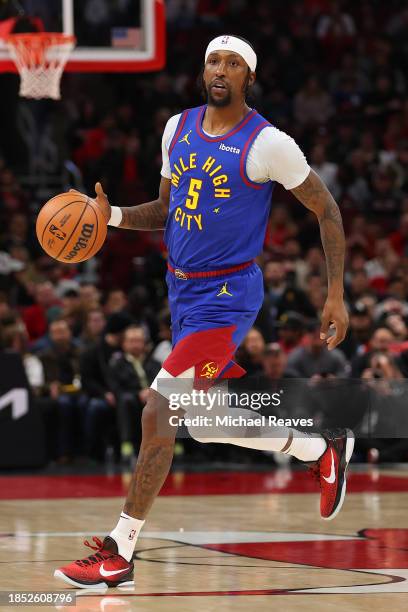 Kentavious Caldwell-Pope of the Denver Nuggets dribbles against the Chicago Bulls during the first half at the United Center on December 12, 2023 in...