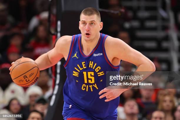 Nikola Jokic of the Denver Nuggets dribbles up the court against the Chicago Bulls during the first half at the United Center on December 12, 2023 in...