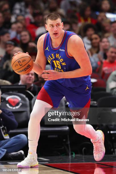 Nikola Jokic of the Denver Nuggets dribbles up the court against the Chicago Bulls during the first half at the United Center on December 12, 2023 in...