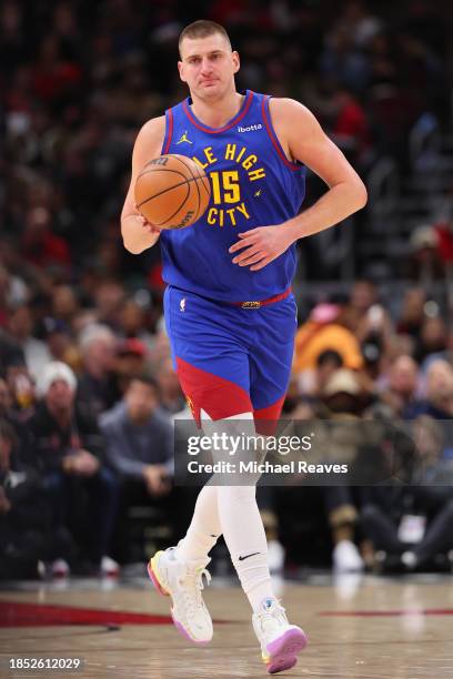 Nikola Jokic of the Denver Nuggets dribbles up the court against the Chicago Bulls during the first half at the United Center on December 12, 2023 in...