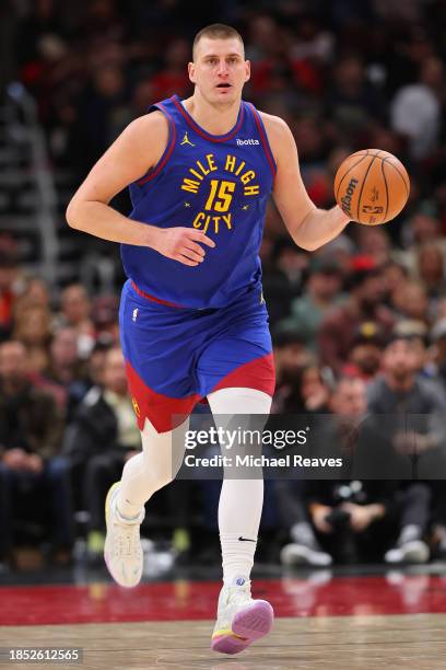 Nikola Jokic of the Denver Nuggets dribbles up the court against the Chicago Bulls during the first half at the United Center on December 12, 2023 in...