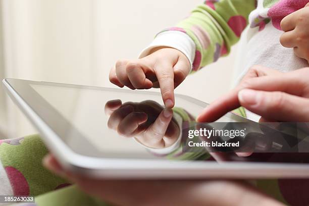 tablet fun - ipad touching stock pictures, royalty-free photos & images
