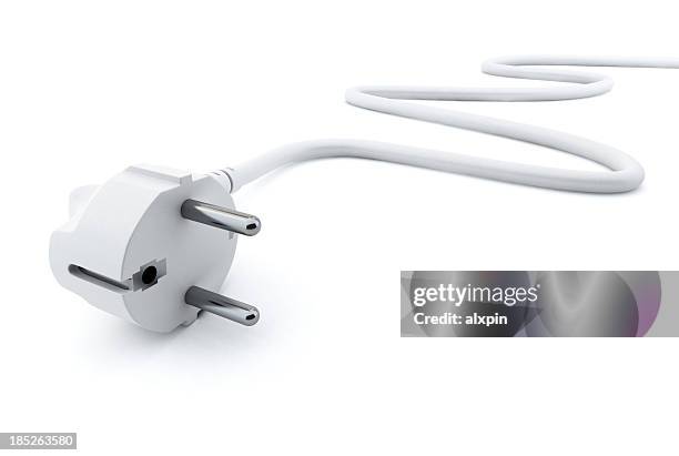 white two pronged plug on a white background - electric stockfoto's en -beelden