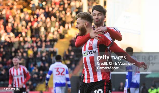 Lincoln City's Ted Bishop, left, celebrates scoring the opening goal with team-mate Danny Mandroiu during the Sky Bet League One match between...