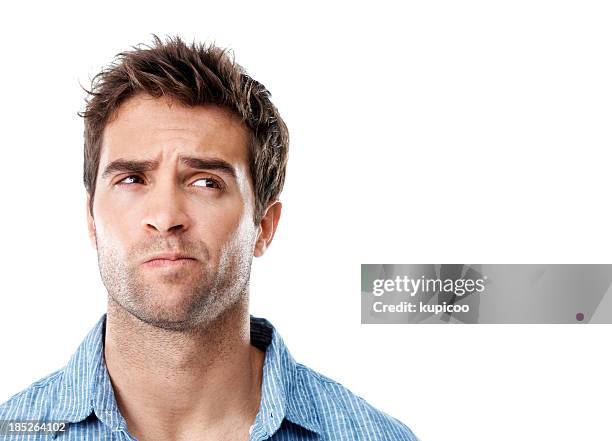 handsome young man in striped shirt with a frown - glaring meaning stock pictures, royalty-free photos & images