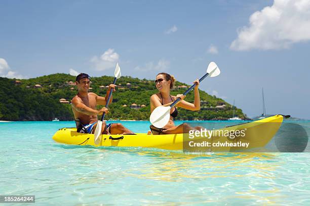 young couple kayaking in the caribbean - caribbean resort stock pictures, royalty-free photos & images