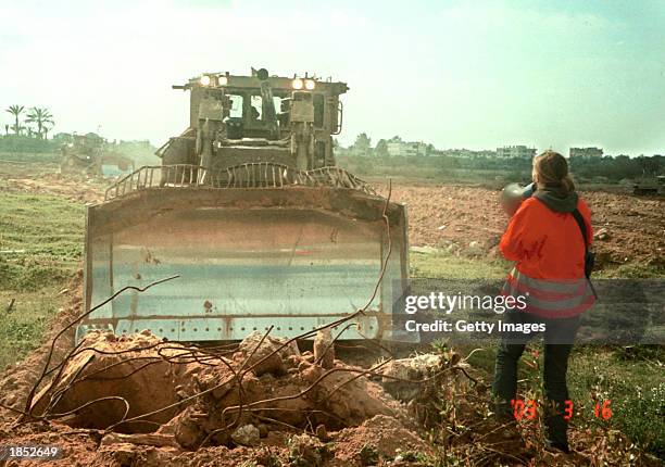American peace activist Rachel Corrie tries to stop an Israeli bulldozer from destroying Palestinian land March 16, 2003 in the Rafah refugee camp in...