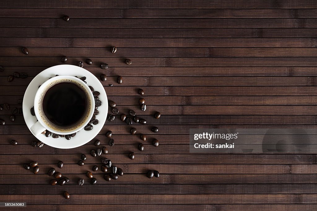 Cup of fresh coffee on dark wood background