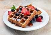 Waffles With Fruit and Maple Syrup on a Marble Counter.