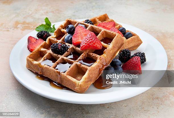 waffles with fruit and maple syrup on a marble counter. - syrup stock pictures, royalty-free photos & images