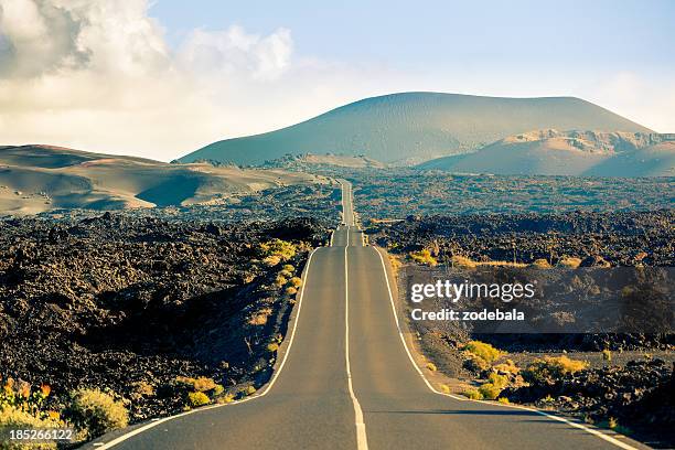 road in timanfaya national park, canary islands - lanzarote stock pictures, royalty-free photos & images